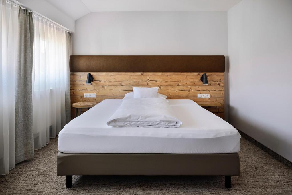 Postel nebo postele na pokoji v ubytování ApartHotel Rose
