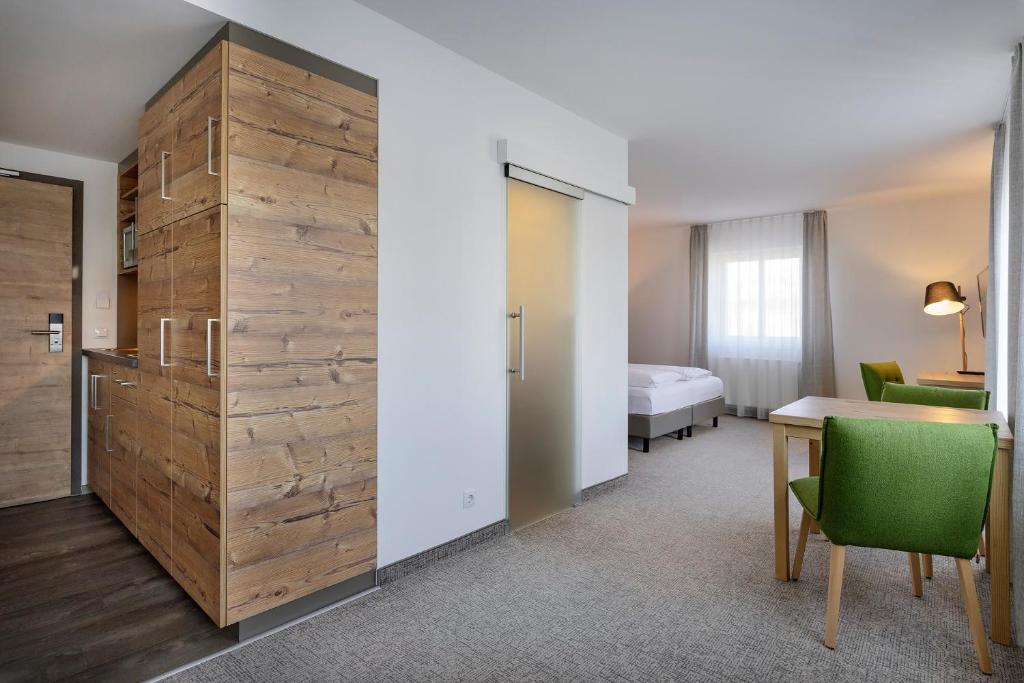 Postel nebo postele na pokoji v ubytování ApartHotel Rose