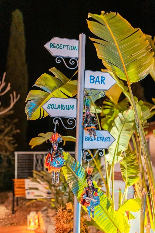 a street sign with a bunch of street signs at Taormina Garden Hotel in Taormina