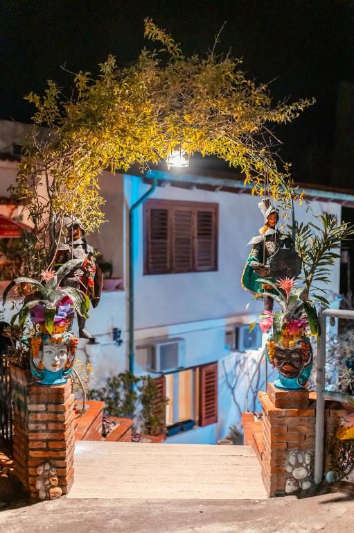 a house with a blue and white at Taormina Garden Hotel in Taormina