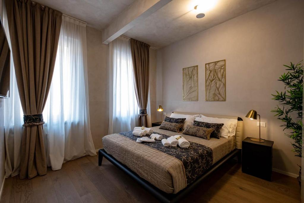 a bedroom with a bed with two teddy bears on it at Verona Romana Apartments in Verona
