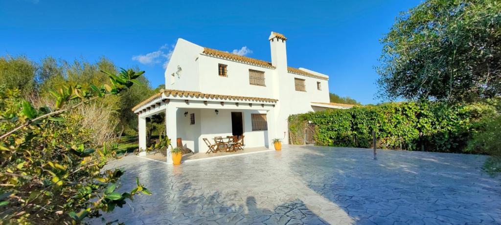 una casa blanca con un patio delante en La Quinta de María Luisa, en Zahora