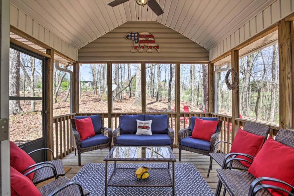 a screened in porch with blue and red pillows at Less than 3 miles to Downtown with firepit in Ellijay