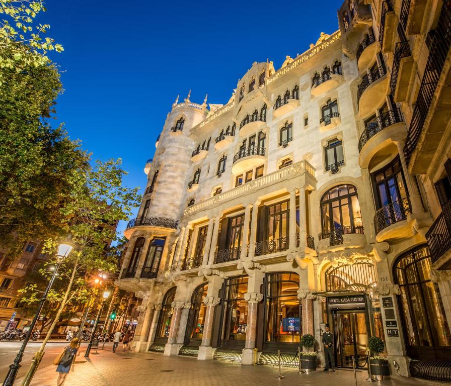 a large white building on a street at night at Hotel Casa Fuster G.L Monumento in Barcelona