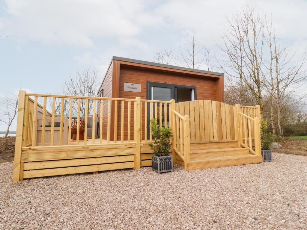 a wooden house with a gate and a fence at The Hideaway Pod in Clitheroe