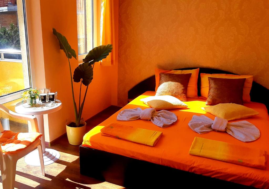 a bedroom with a bed with towels and a window at Къща за гости Вълчеви Несебър in Nesebar