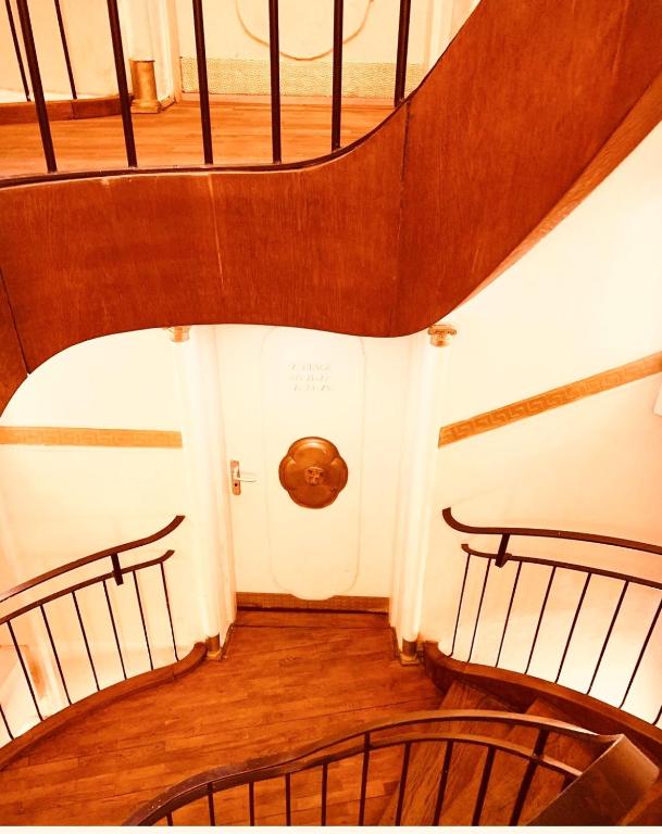 a spiral staircase in a building with wooden floors at Hotel Lux in Munich