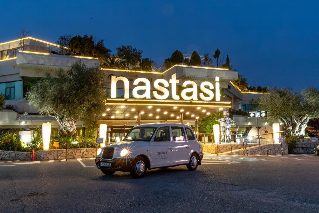 a small car parked in front of a restaurant at Nastasi Hotel & Spa in Lleida