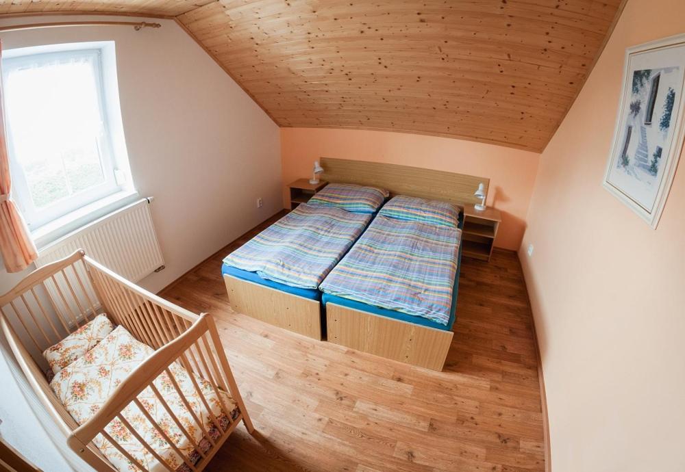 Postel nebo postele na pokoji v ubytování Penzion Svatá Trojice