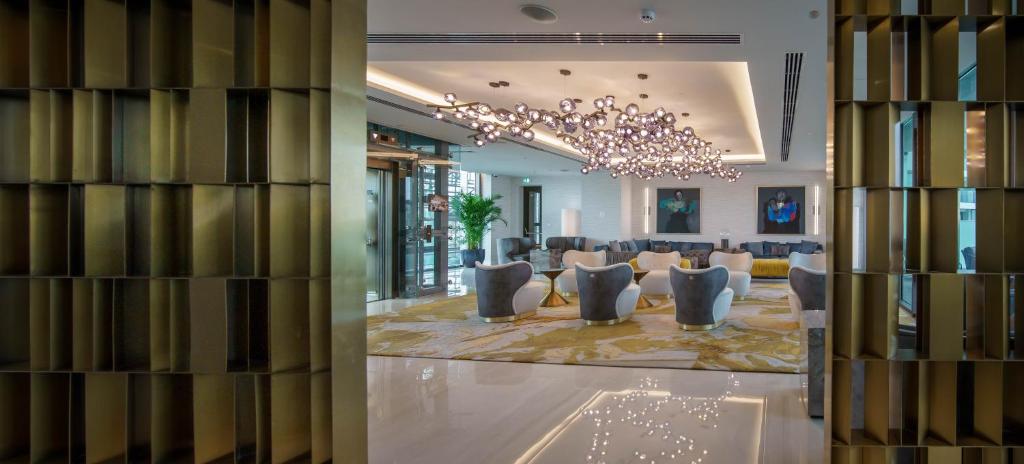 a lobby with a chandelier and a waiting room at Limassol Del Mar in Limassol