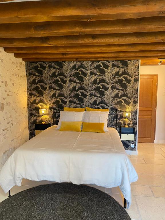 sypialnia z dużym łóżkiem ze ścianą w obiekcie La Ferme de Fontenelle w mieście Amillis