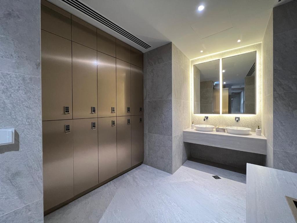 a bathroom with two sinks and a mirror at Limassol Del Mar in Limassol