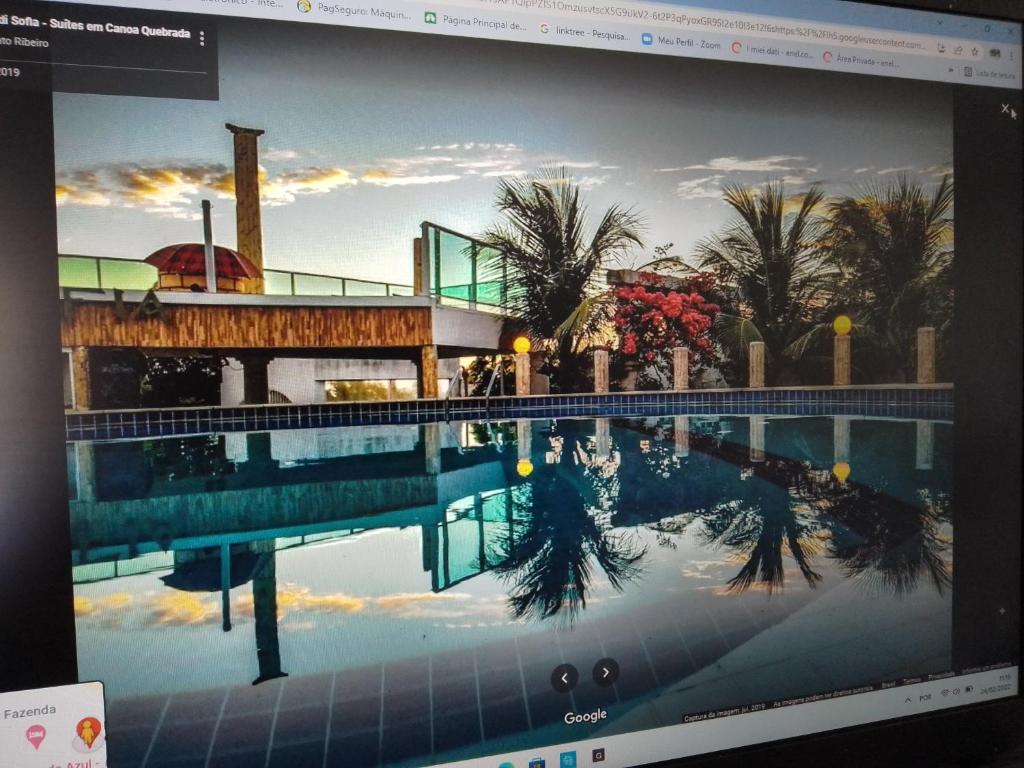 a computer screen with a picture of a swimming pool at Il Mondo Di Sofia in Canoa Quebrada