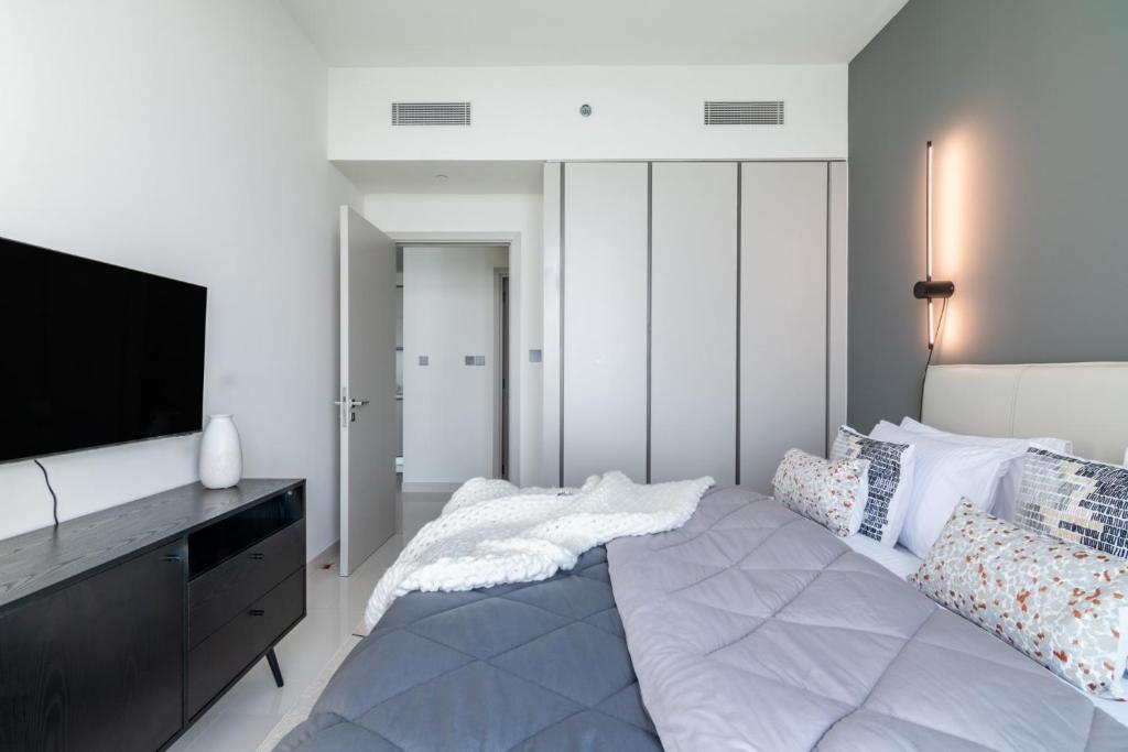 Postel nebo postele na pokoji v ubytování The Smart Concierge - Sunrise Bay beachfront