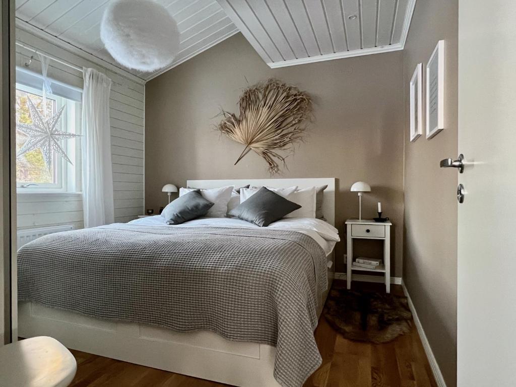 a bedroom with a bed with a white bedspread at The Novac's Cottage in Råneå