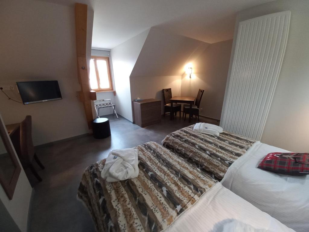 Postel nebo postele na pokoji v ubytování SARL DU PARC Hôtel Les Tremplins