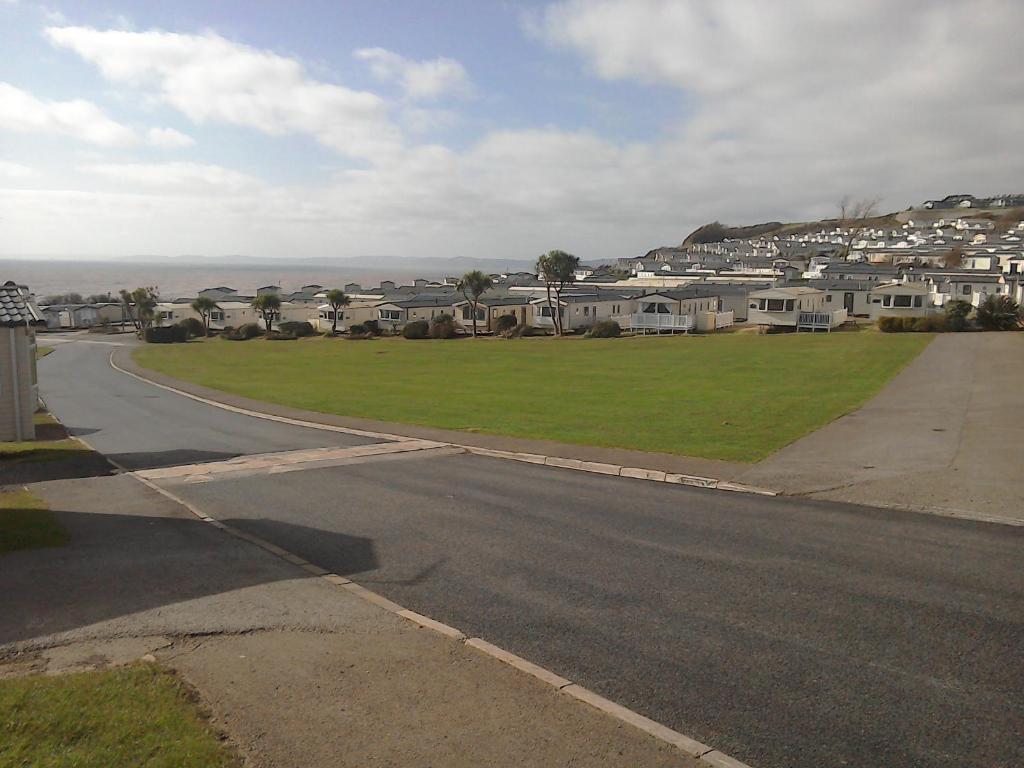 an empty street in a residential neighborhood with houses at 54 Apple Grove in Exmouth