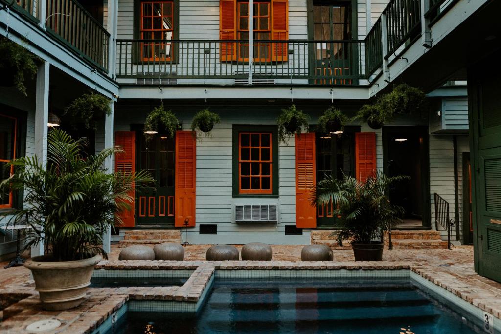 una casa con piscina frente a ella en The Frenchmen, en Nueva Orleans