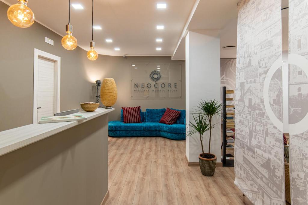 a living room with a blue couch in the background at Neocore in Naples