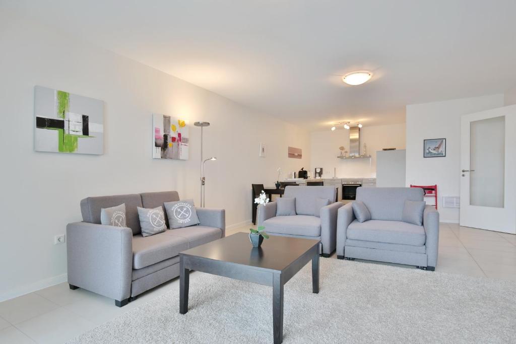 a living room with two couches and a coffee table at Villa Mér Baltique Villa Mér Baltique Appartement 13 in Timmendorfer Strand