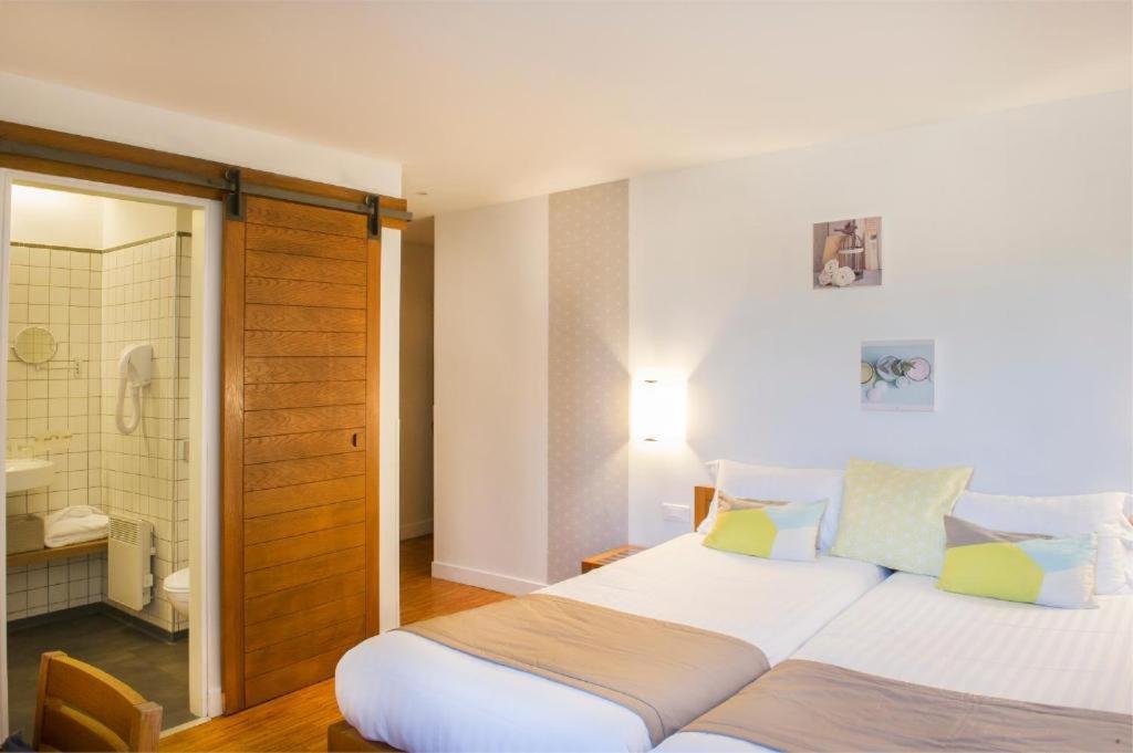 a bedroom with a large bed and a shower at Domaine De Barres in Langogne