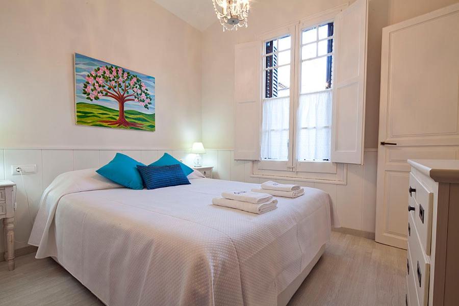 Un dormitorio blanco con una cama con toallas. en Stay U-nique Apartments Gaudi II, en Barcelona