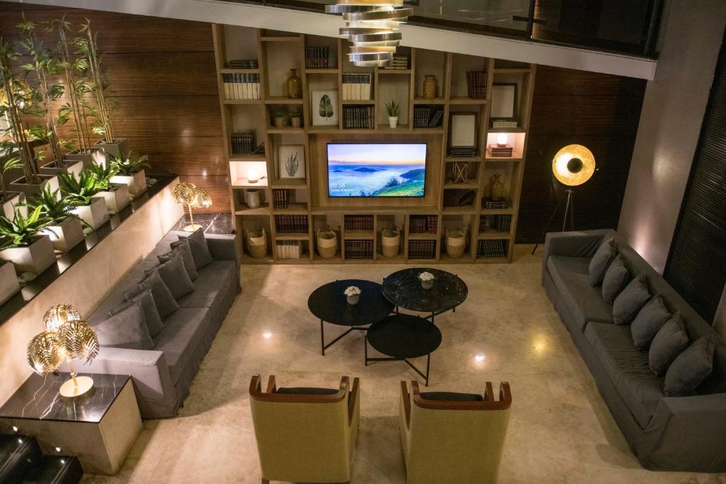 an overhead view of a living room with couches and a television at Grand King Hotel in Buenos Aires