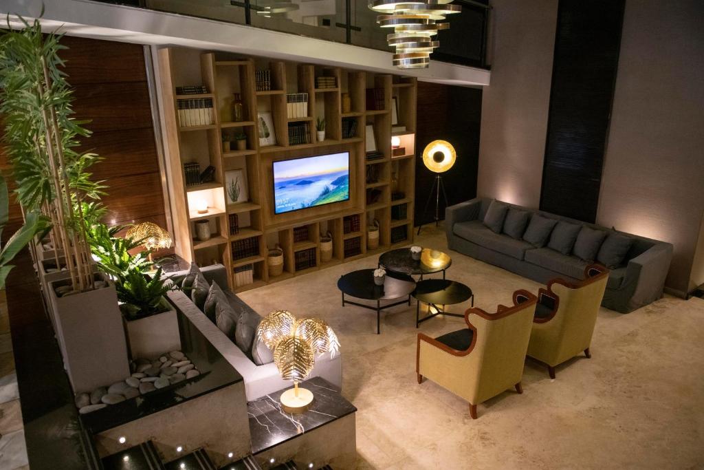 a living room with a couch and a tv at Grand King Hotel in Buenos Aires