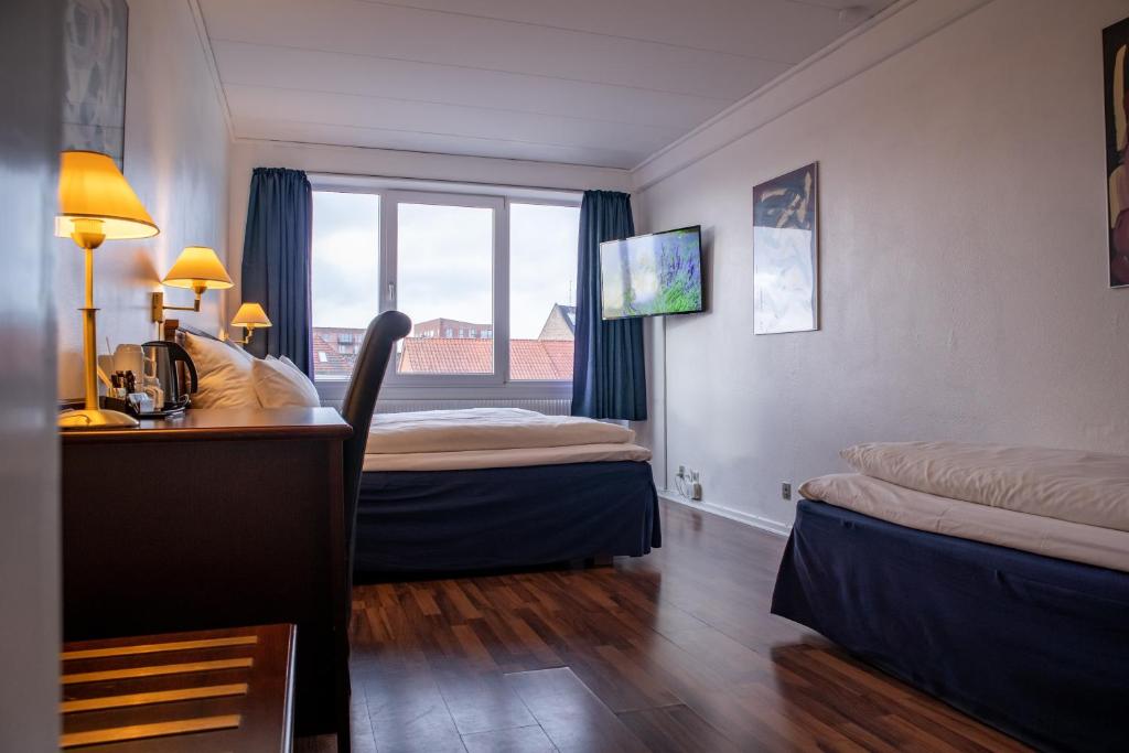 Postel nebo postele na pokoji v ubytování Hotel Phønix Hjørring