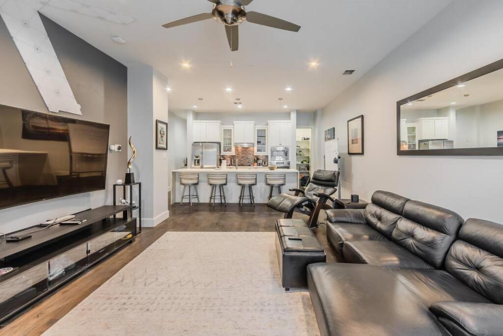 a living room with a couch and a bar at Stunning Townhome Near Uptown in Dallas
