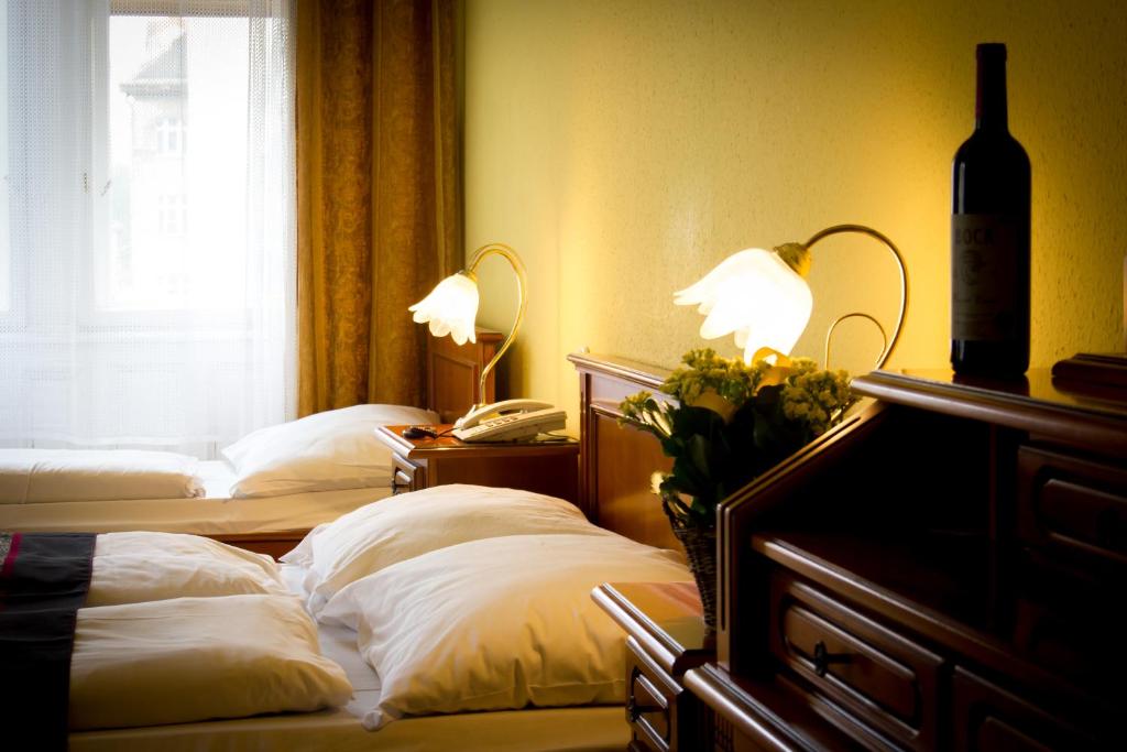 Postel nebo postele na pokoji v ubytování City Hotel UNIO superior