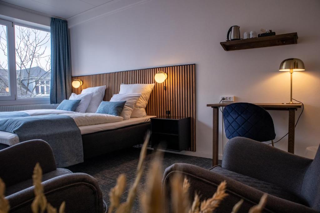 Postel nebo postele na pokoji v ubytování Hotel Phønix Hjørring