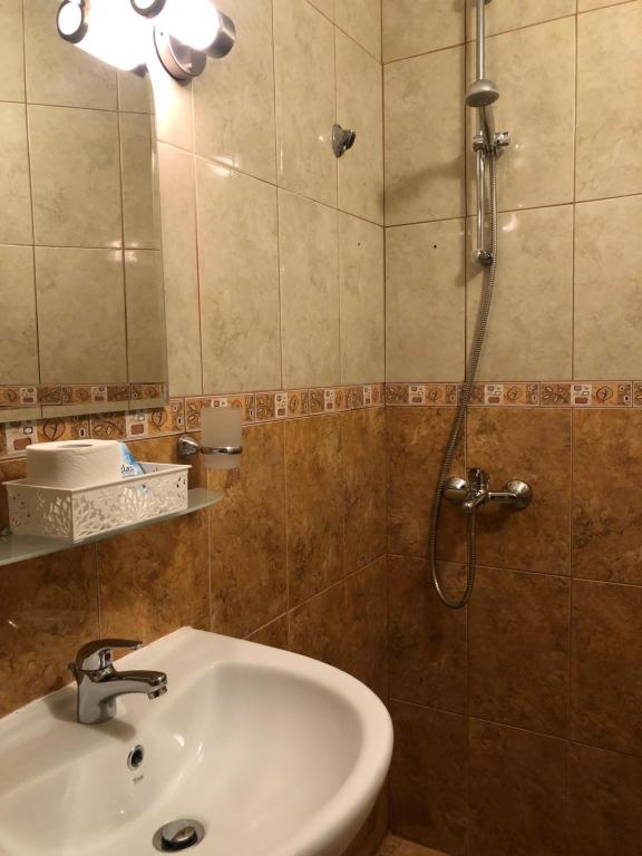 a bathroom with a sink and a shower at Hotel Silver in Sozopol
