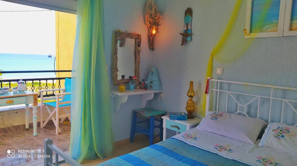 a bedroom with a bed and a view of the ocean at Socrates sea view in Kámpos