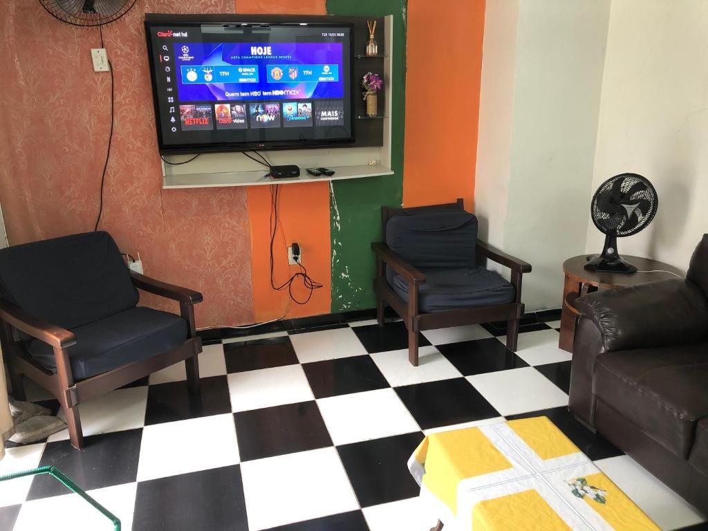 a waiting room with two chairs and a flat screen tv at Casa na melhor localidade de BC in Balneário Camboriú