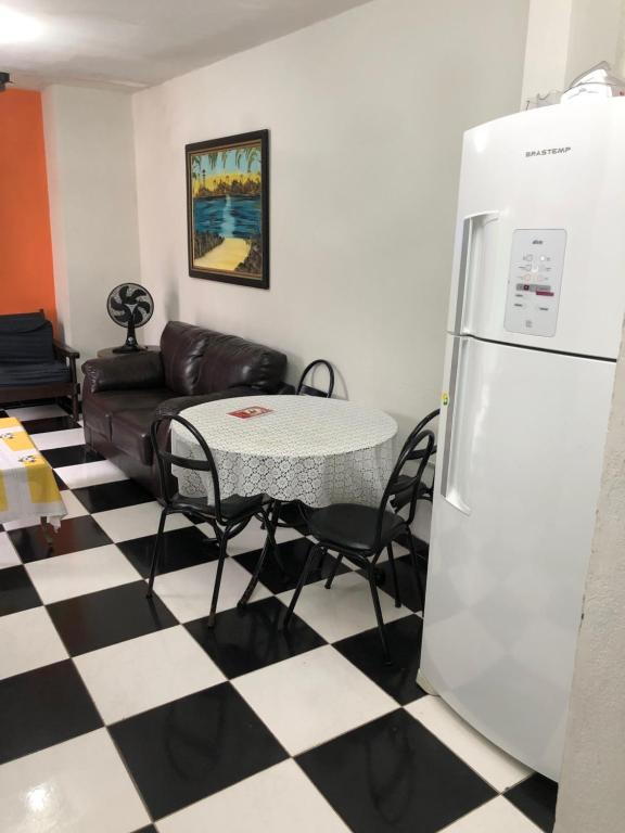 a living room with a refrigerator and a table at Casa na melhor localidade de BC in Balneário Camboriú