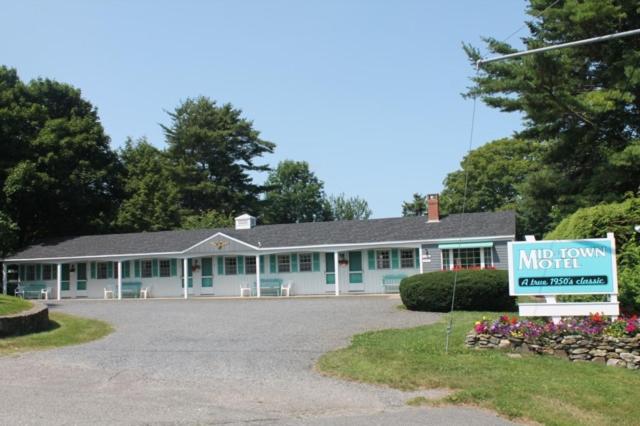 a house with a sign in front of it at Mid-Town Motel in Boothbay Harbor