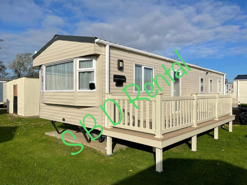 a mobile home with graffiti on the side of it at Summer Breeze Deluxe Caravan Rental in Saint Osyth