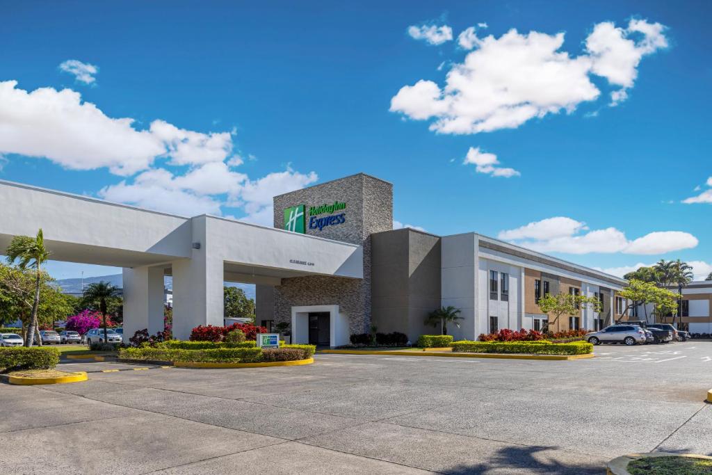 a large office building with a parking lot at Holiday Inn Express San Jose Airport, an IHG Hotel in Alajuela
