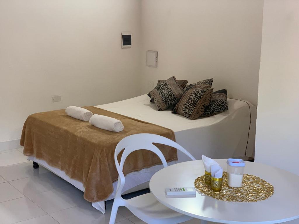 a room with a bed with a table and a tableablish at Las Salinas Hostal in Luque