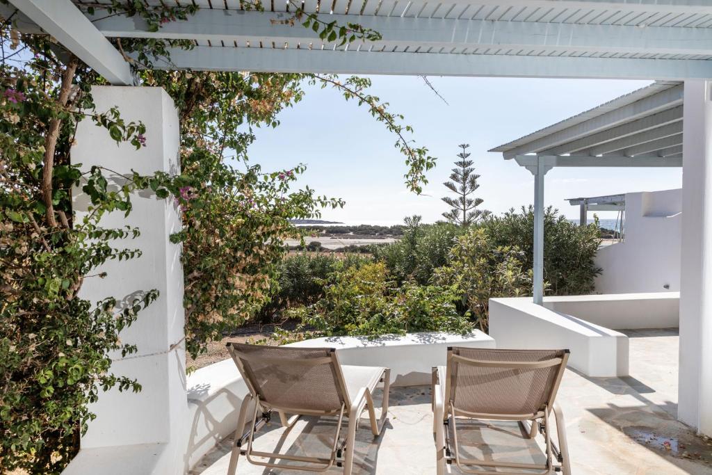 a patio with chairs and a table with a view at Glyfada apartment sea view in Naxos Chora