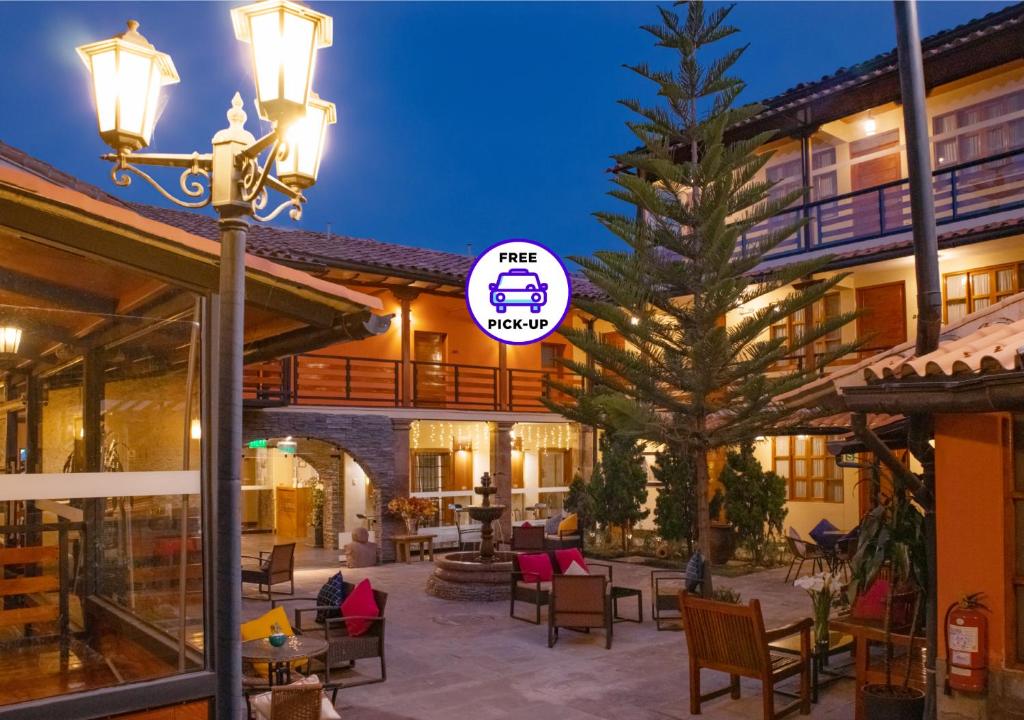 a hotel with a tree in the middle of a courtyard at Union Hotel Cusco in Cusco