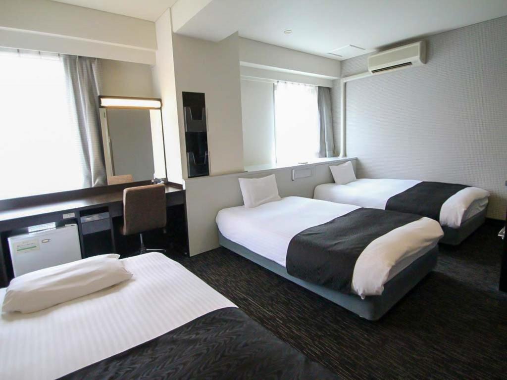 
Tempat tidur dalam kamar di APA Hotel Kumamoto Sakuramachi Bus Terminal Minami
