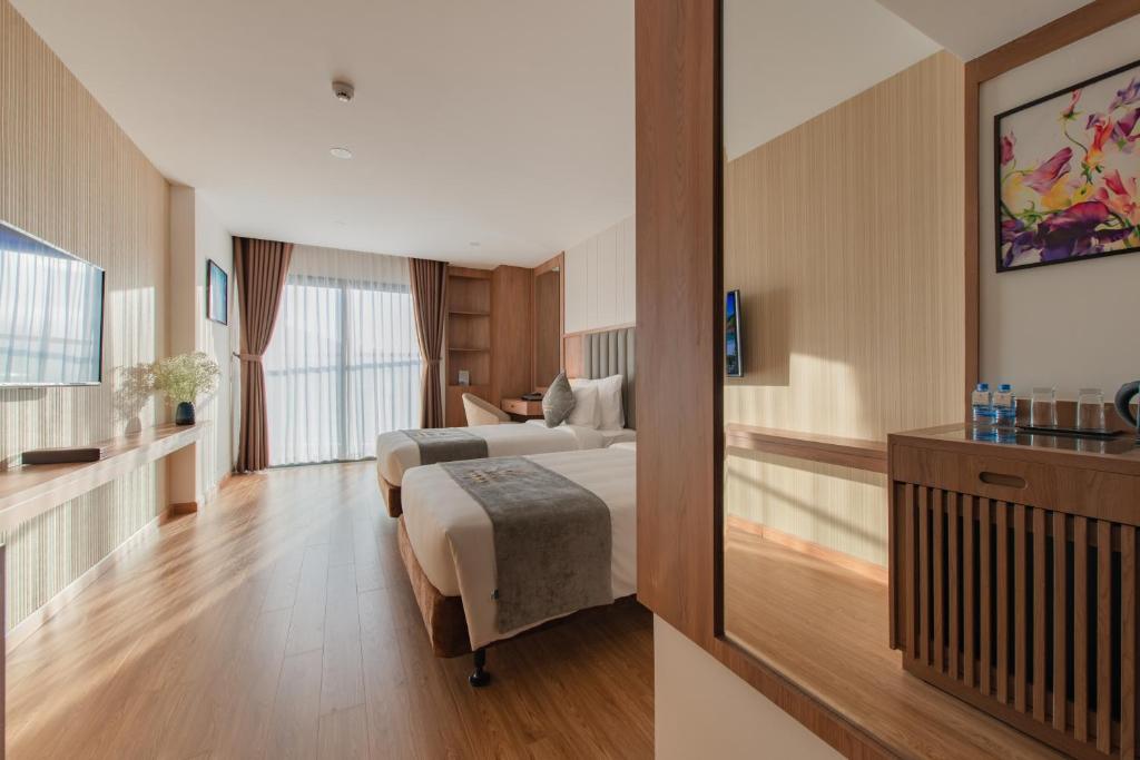 Postel nebo postele na pokoji v ubytování Grand Gosia Hotel