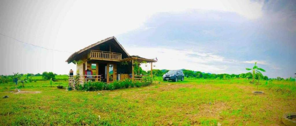 a small house in the middle of a field at Rancho Oco Mahogany Loft Type Villa in Nasugbu