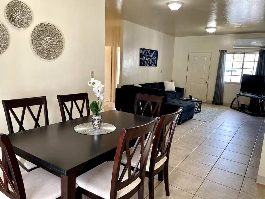 a living room with a table and chairs and a couch at beautiful 4 bedroom tumon house in Tamuning