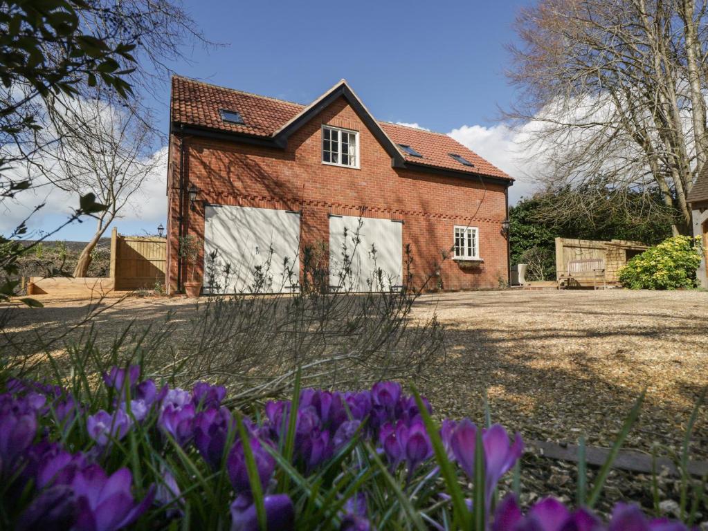 a house with purple flowers in front of it at The Coach House15 in Warminster