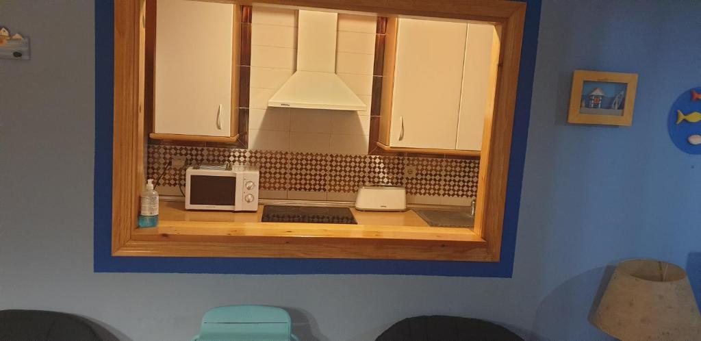 a kitchen with a counter with two microwaves at Apartamentos Atlanterra COSTA Y SOL in Zahara de los Atunes