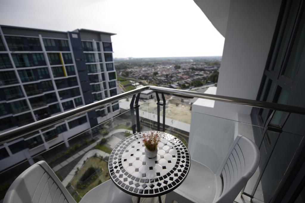 a balcony with a table and chairs on a building at 3BR Jazz Suites Vivacity Megamall Kuching Sarawak in Kuching