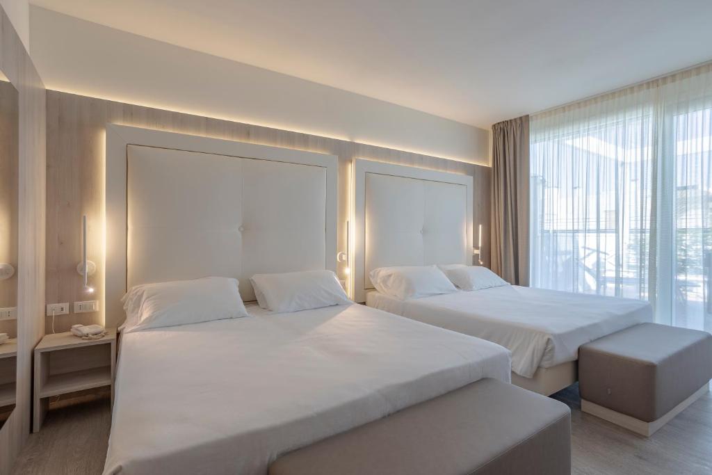 Postel nebo postele na pokoji v ubytování Hotel Doriana